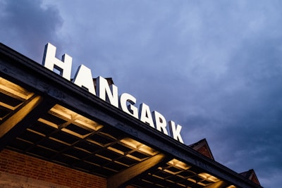 Evening view of the hangar lit warmly, showing a welcoming atmosphere.