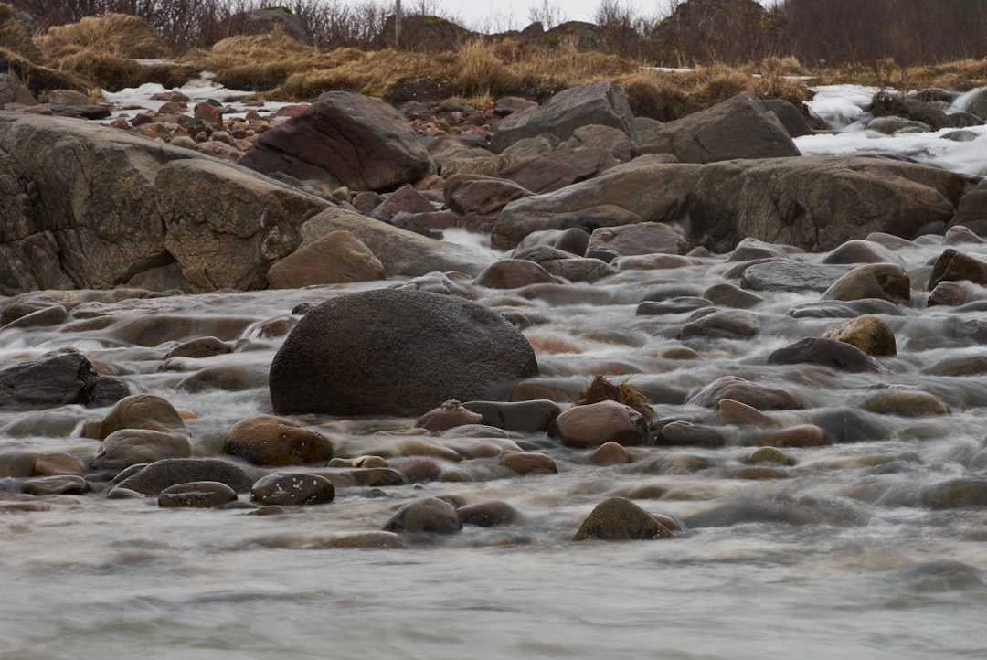 black rocks on river during daytime