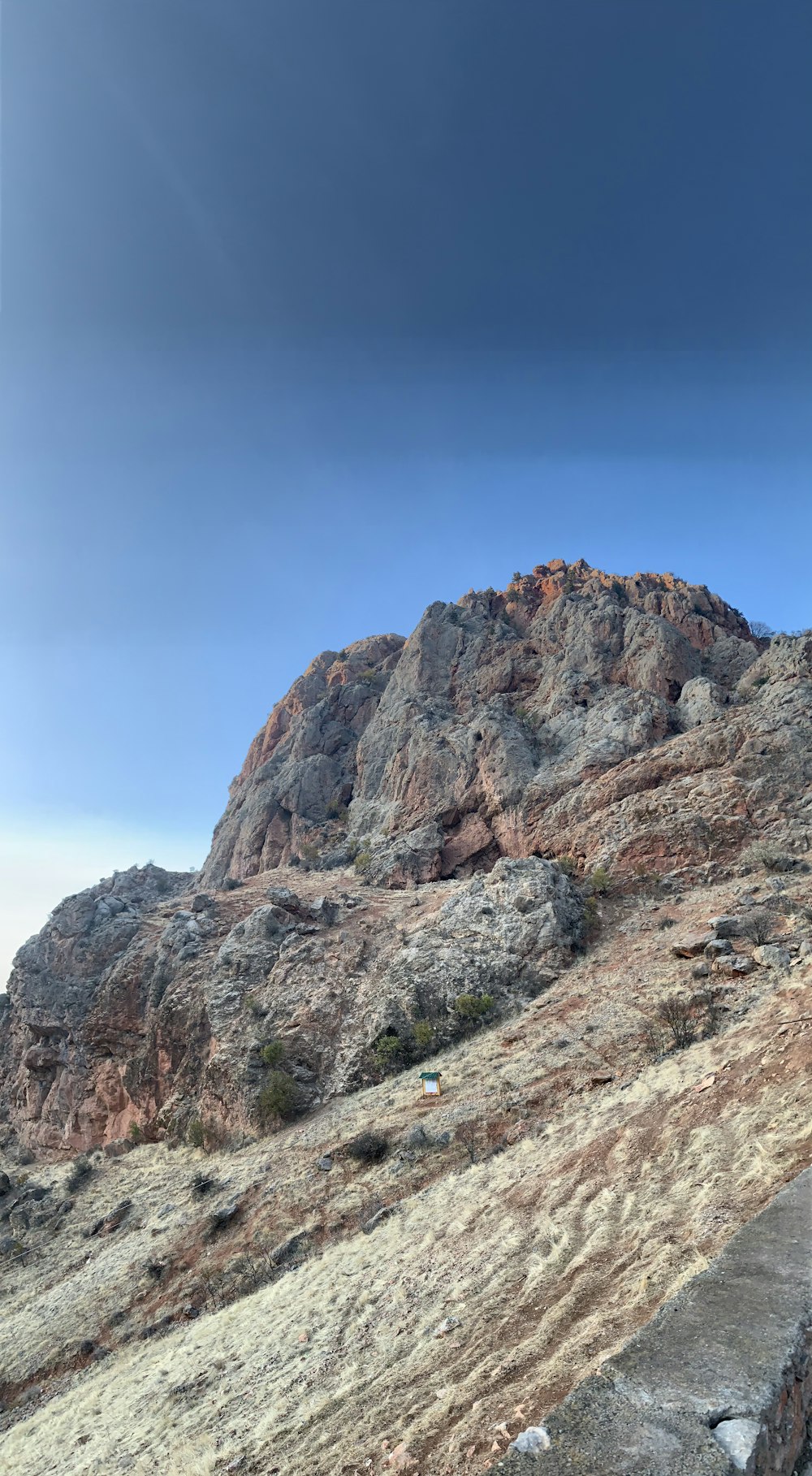 brown rocky mountain under blue sky during daytime