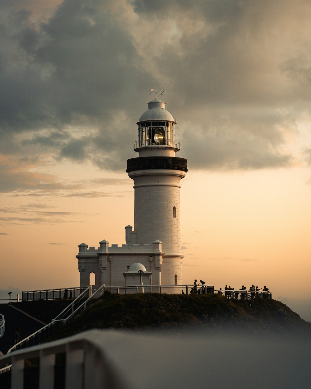 white and black lighthouse under cloudy sky during daytime