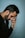 man in black shirt holding telephone