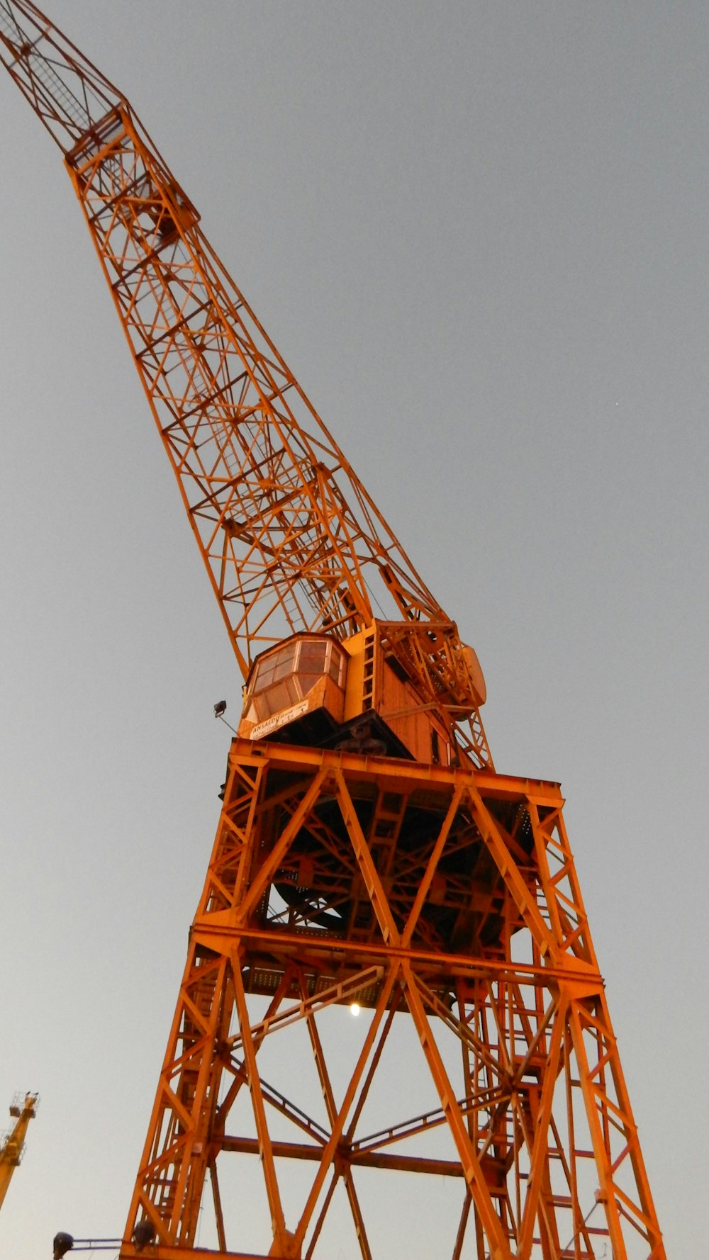 orange crane under blue sky