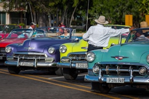 A row of cars in purple and yellow colors lined up for commercial evaluation