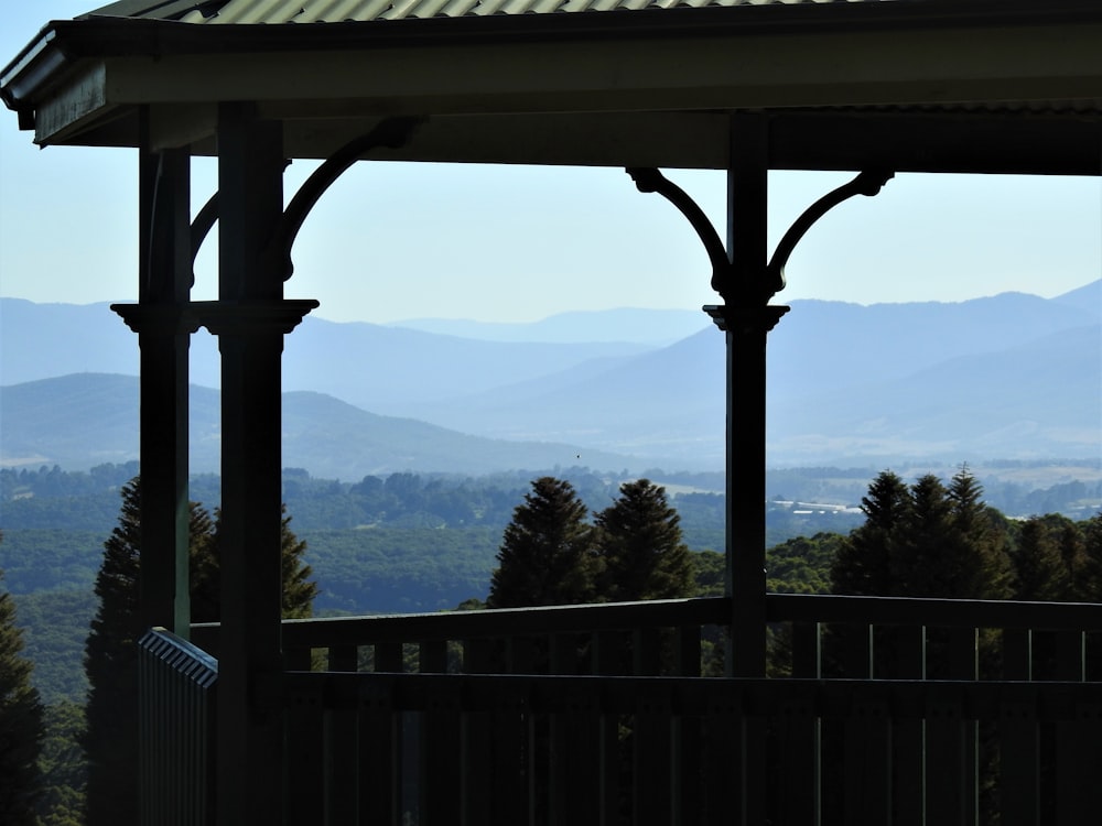 white wooden fence near green mountains during daytime