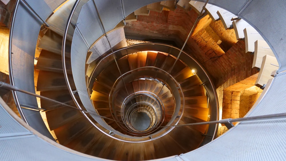 brown spiral staircase with brown wooden railings