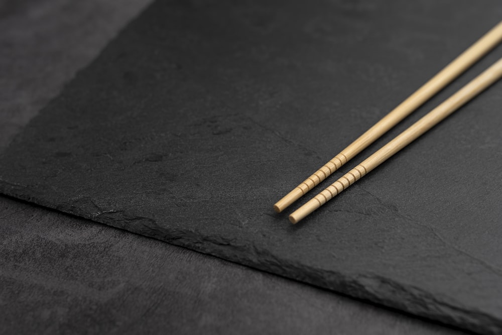 brown wooden sticks on black textile