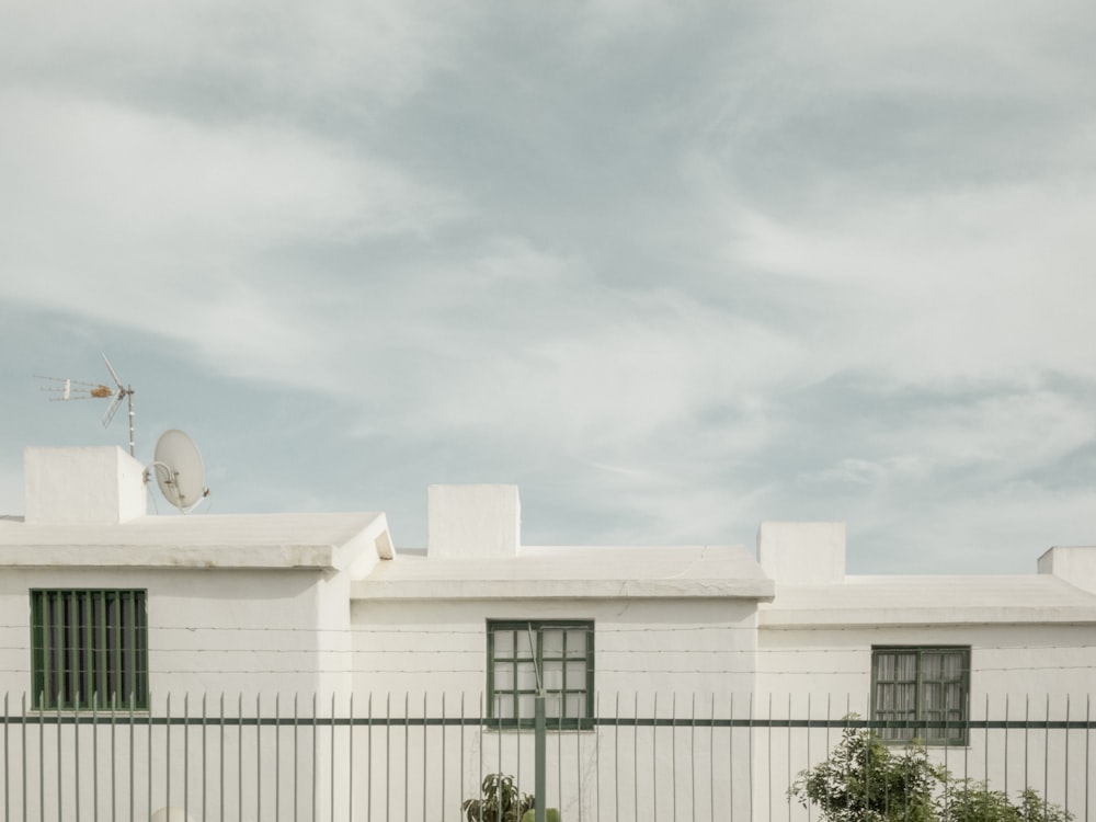 white concrete building under white clouds during daytime