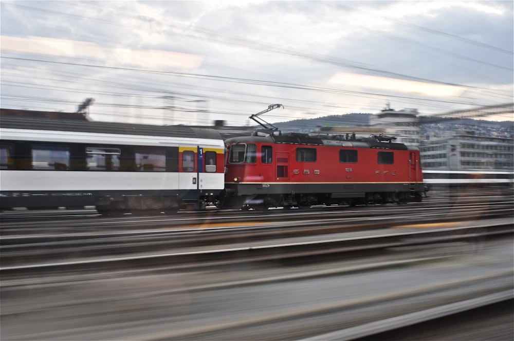 red and white train on train station