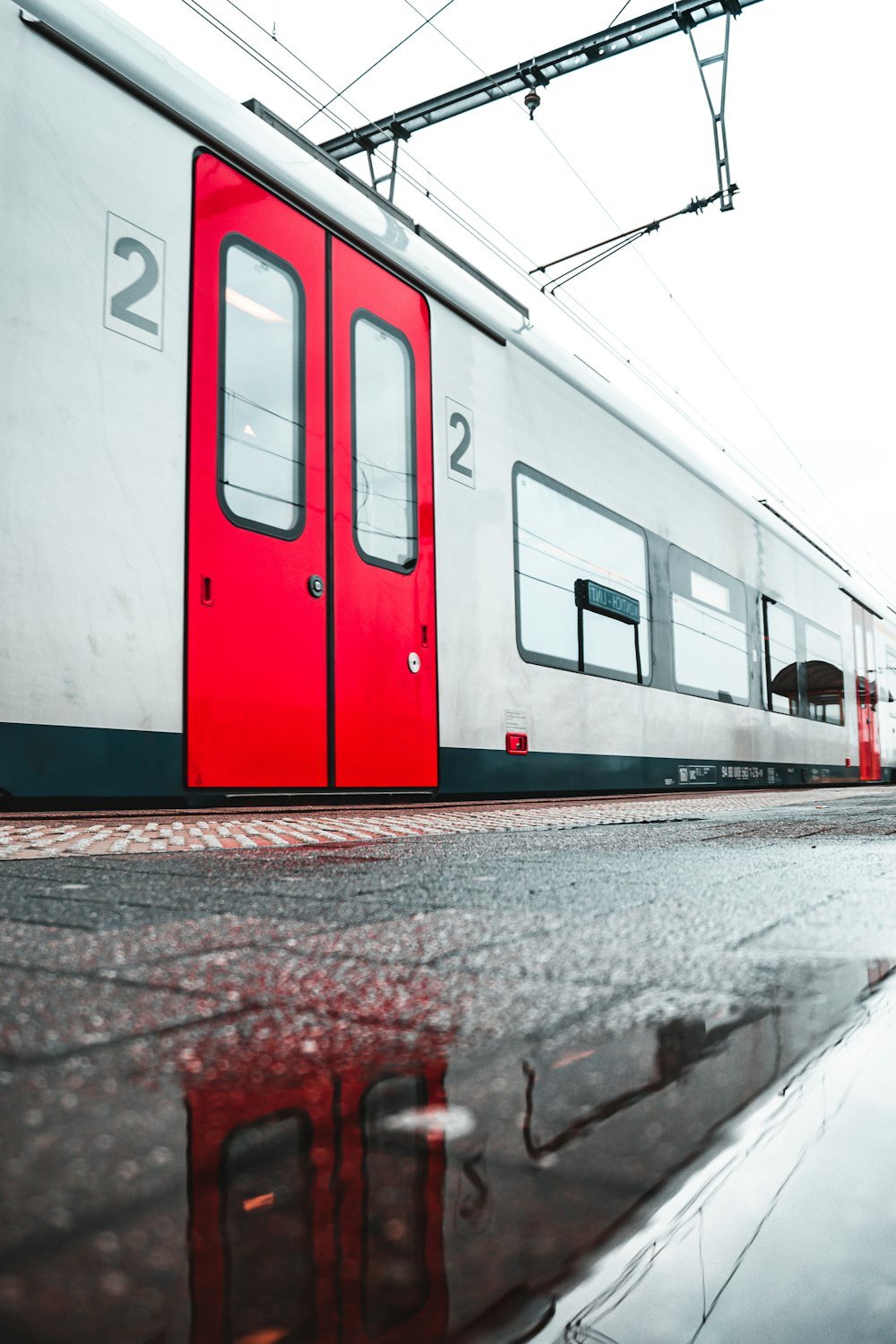 white and red train on train station