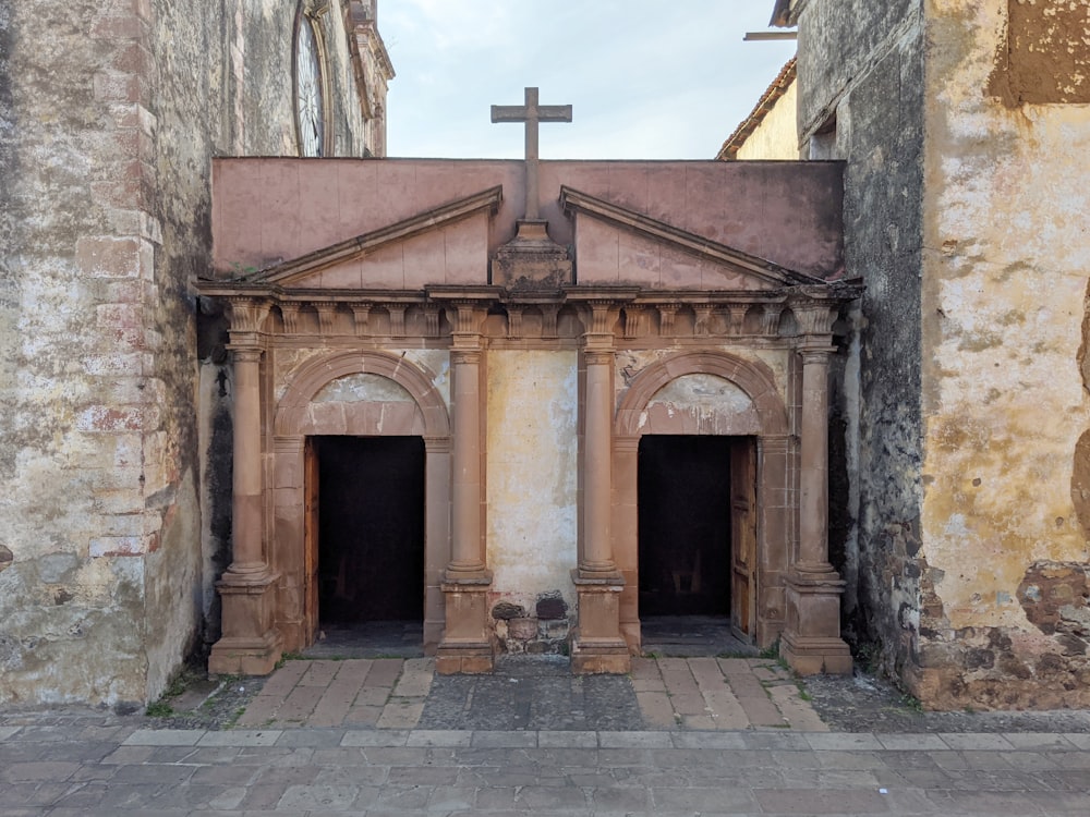 brown concrete building with cross on top