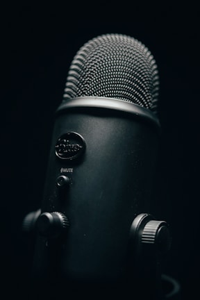 black and silver microphone with black background