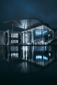 clear glass building near body of water during night time