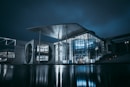white and gray building near body of water during night time