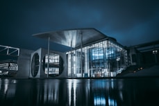 white and gray building near body of water during night time