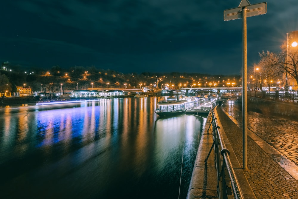 body of water near city buildings during night time