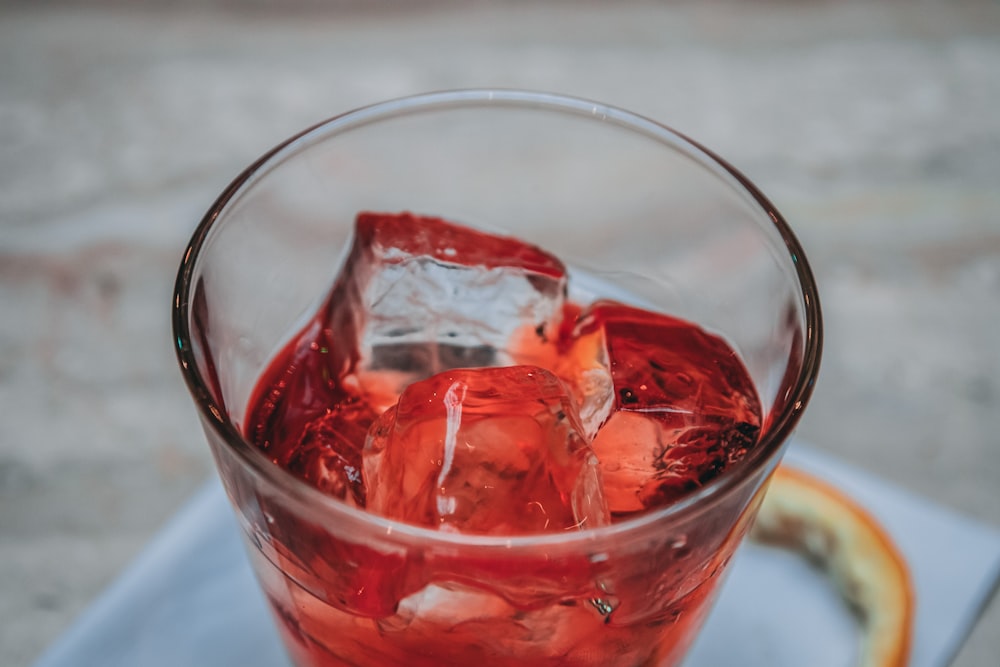 clear drinking glass with red liquid