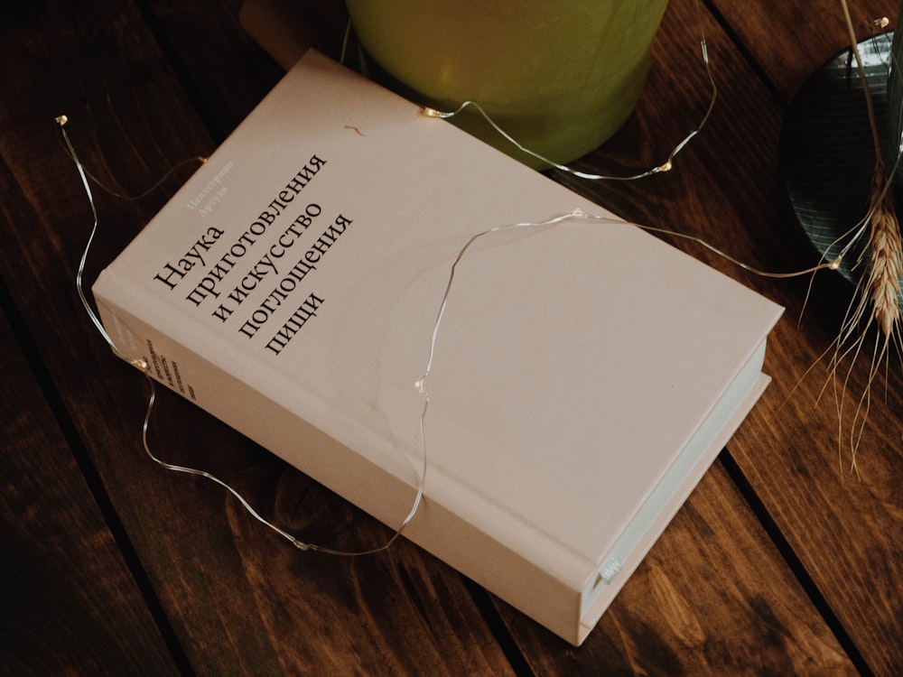 white book on brown wooden table