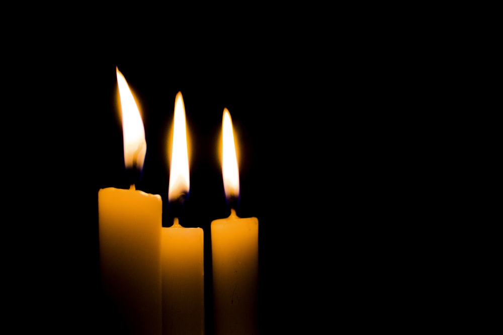 white candles on black background