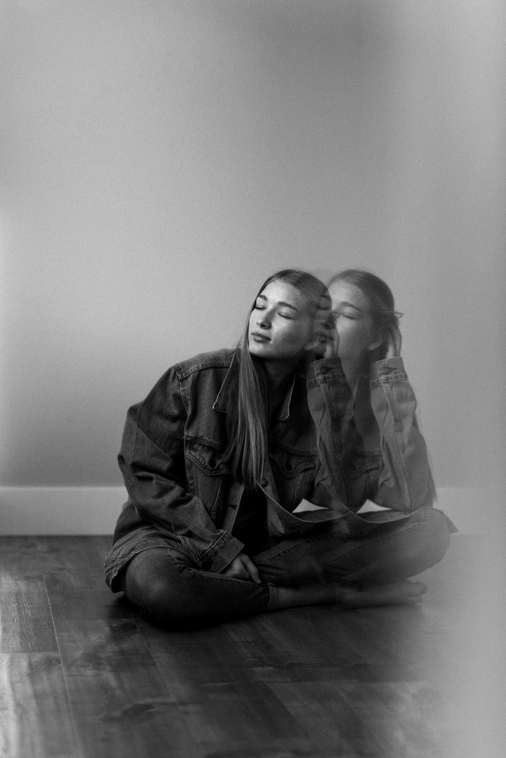 grayscale photo of man and woman sitting on floor