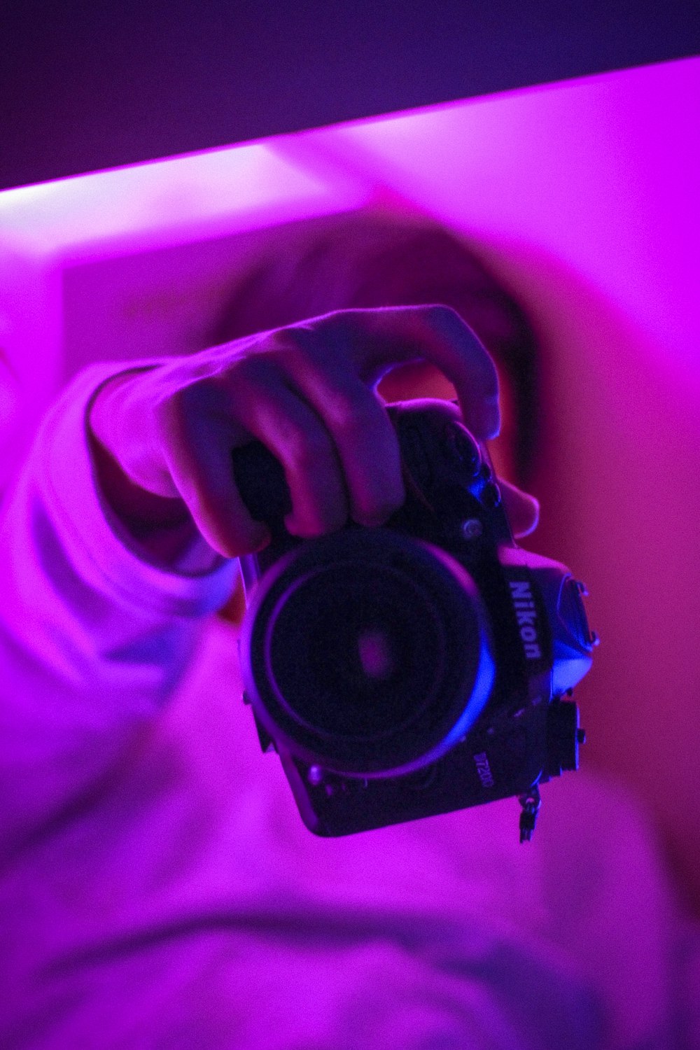 person holding black dslr camera