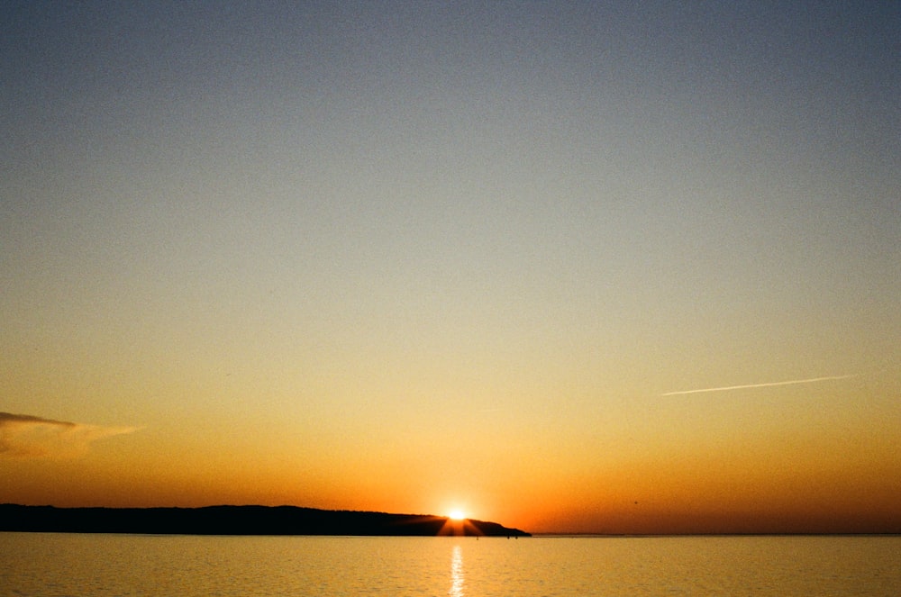 body of water during sunset