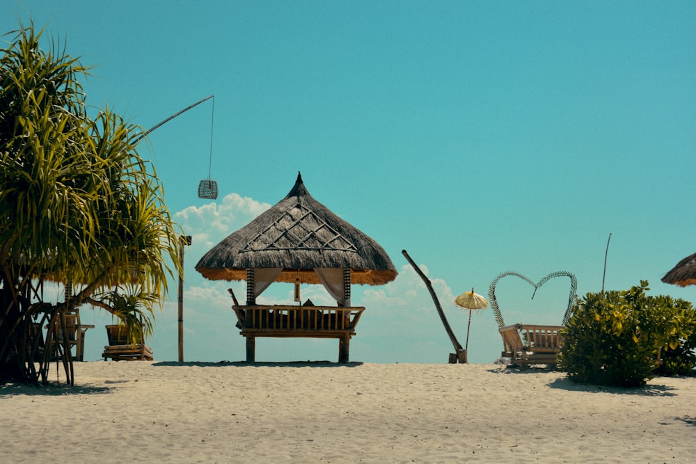 brown wooden beach lounge chairs on beach during daytime