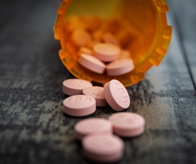 white medication pill on orange plastic container