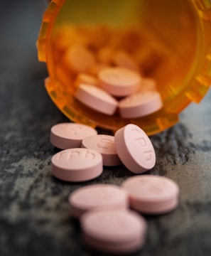 white medication pill on orange plastic container