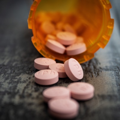 white medication pill on orange plastic container