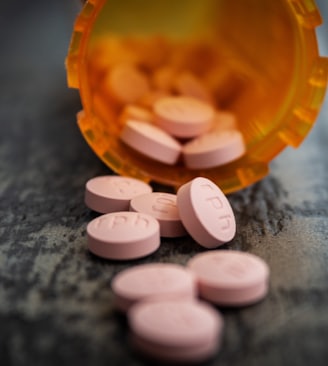 white medication pill on orange plastic container