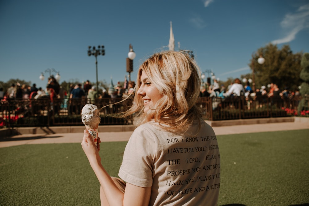 girl in white crew neck t-shirt holding ice cream cone