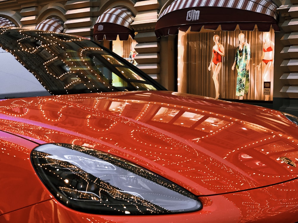 Coche Ferrari rojo aparcado cerca del edificio