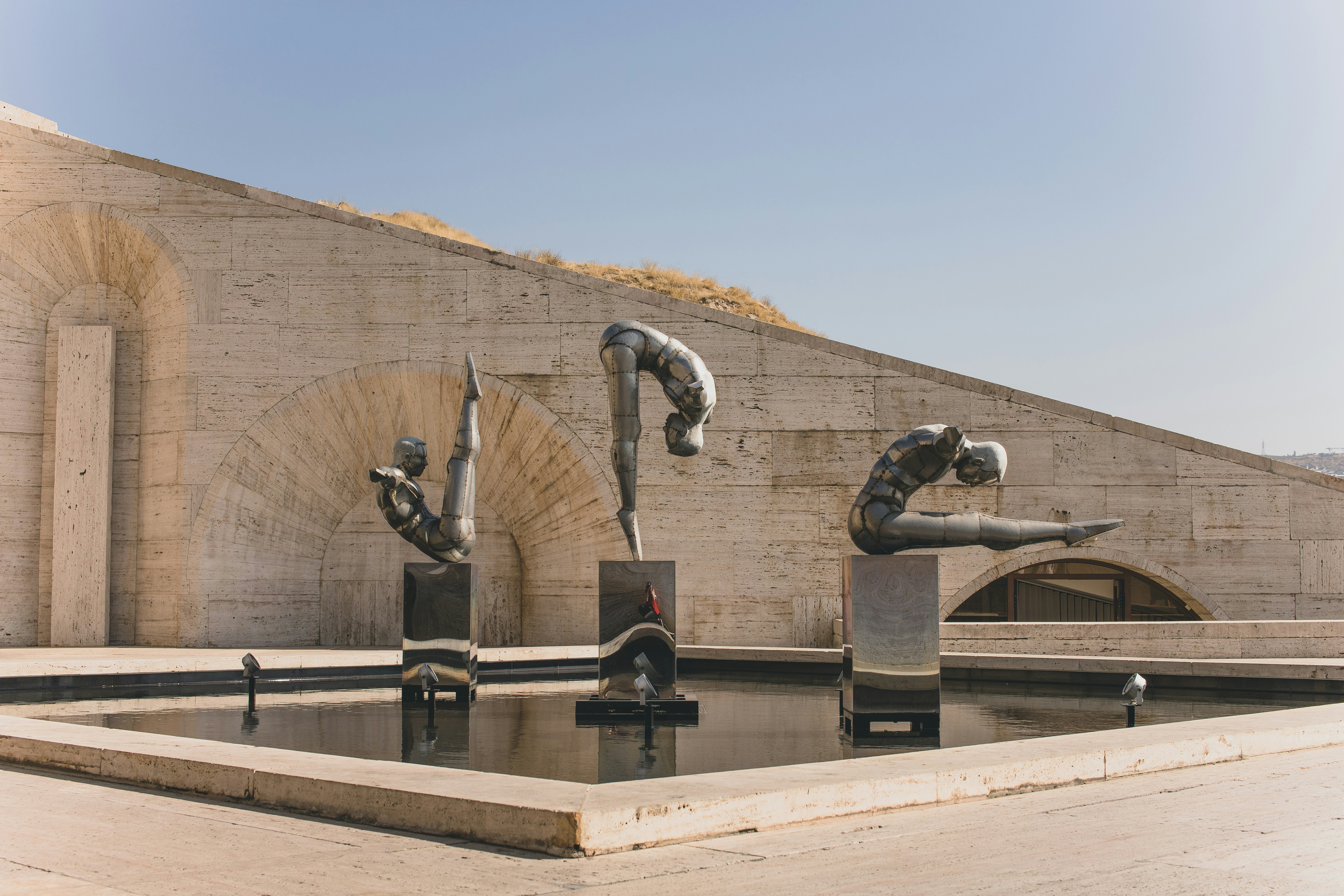 grey statue near brown mountain during daytime