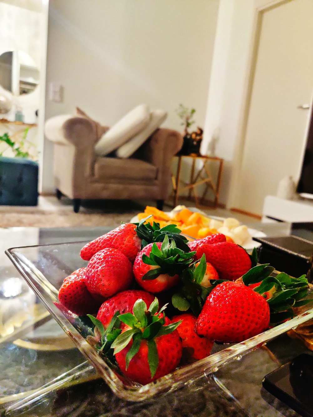strawberries on clear glass bowl