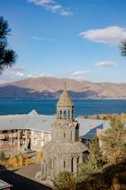 white and brown concrete building near body of water during daytime