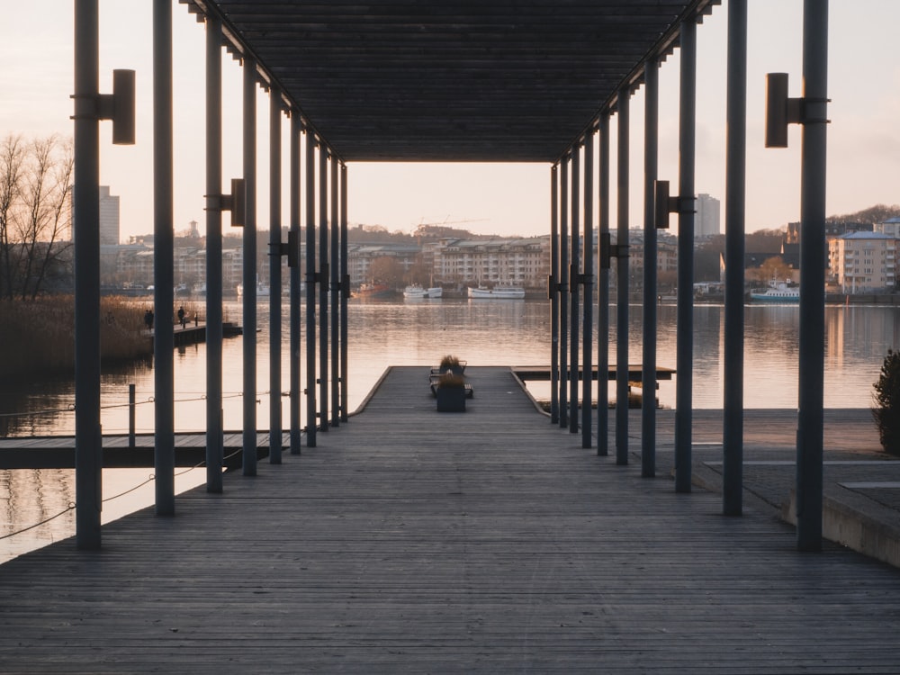 brown wooden dock on body of water during daytime