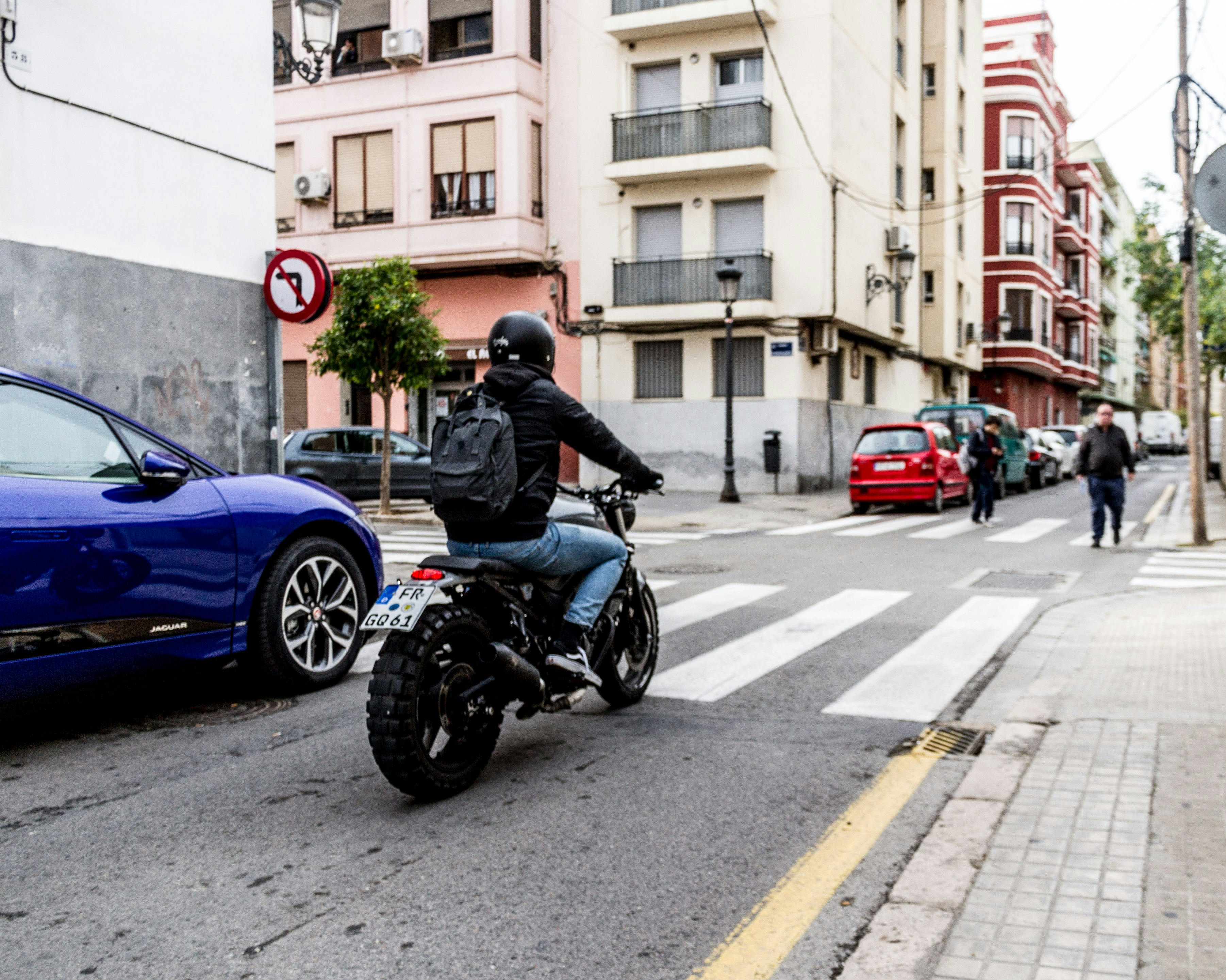 man in black helmet riding blue sports bike on road during daytime