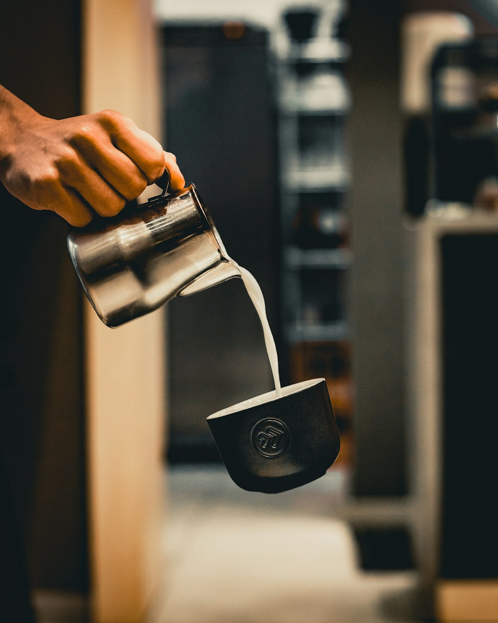 person pouring water on silver cup