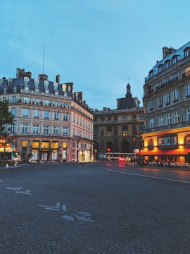 Luxury boutique hotel facade in a European city at sunset.