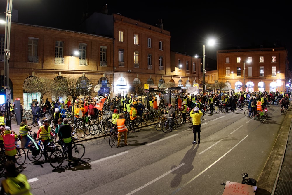 people riding bicycles on road during nighttime