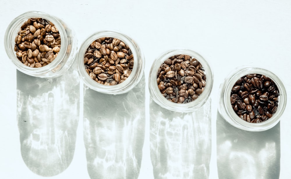 brown beans in clear glass containers