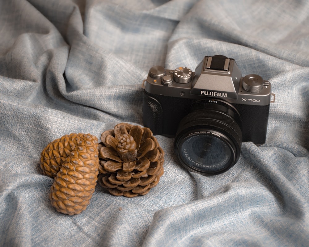 black nikon dslr camera on blue and white textile