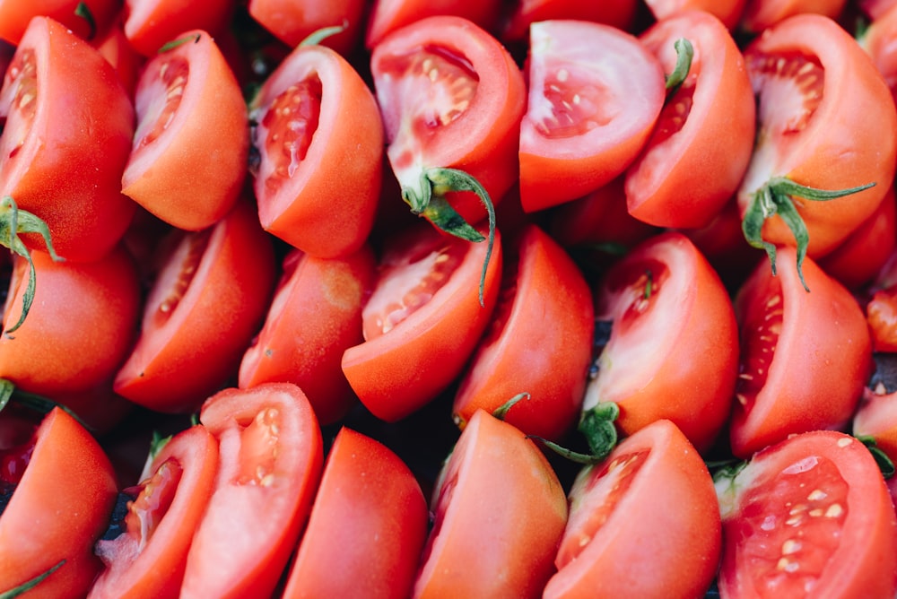 red sliced tomato in close up photography