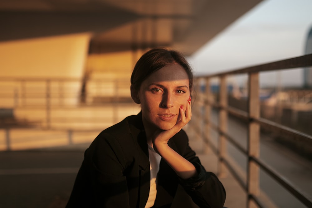 woman in black jacket sitting on chair