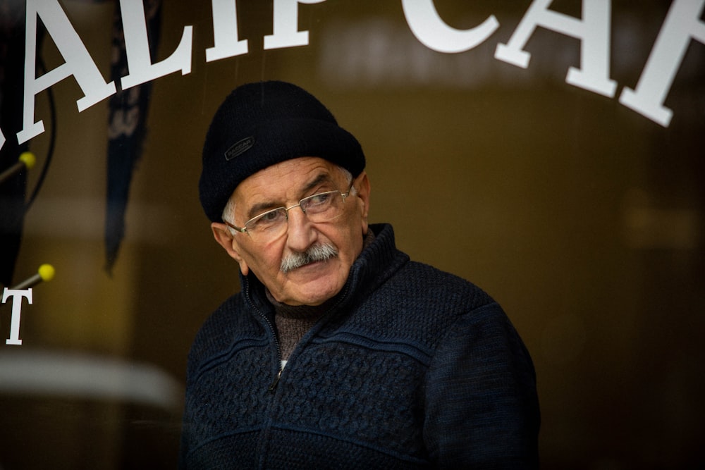 man in black knit cap and blue zip up jacket