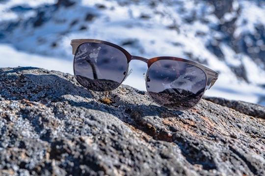 brown framed sunglasses on rocky ground in Gosaikunda Nepal