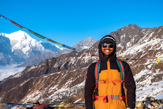 man in orange and black jacket wearing black goggles in Gosaikunda Nepal