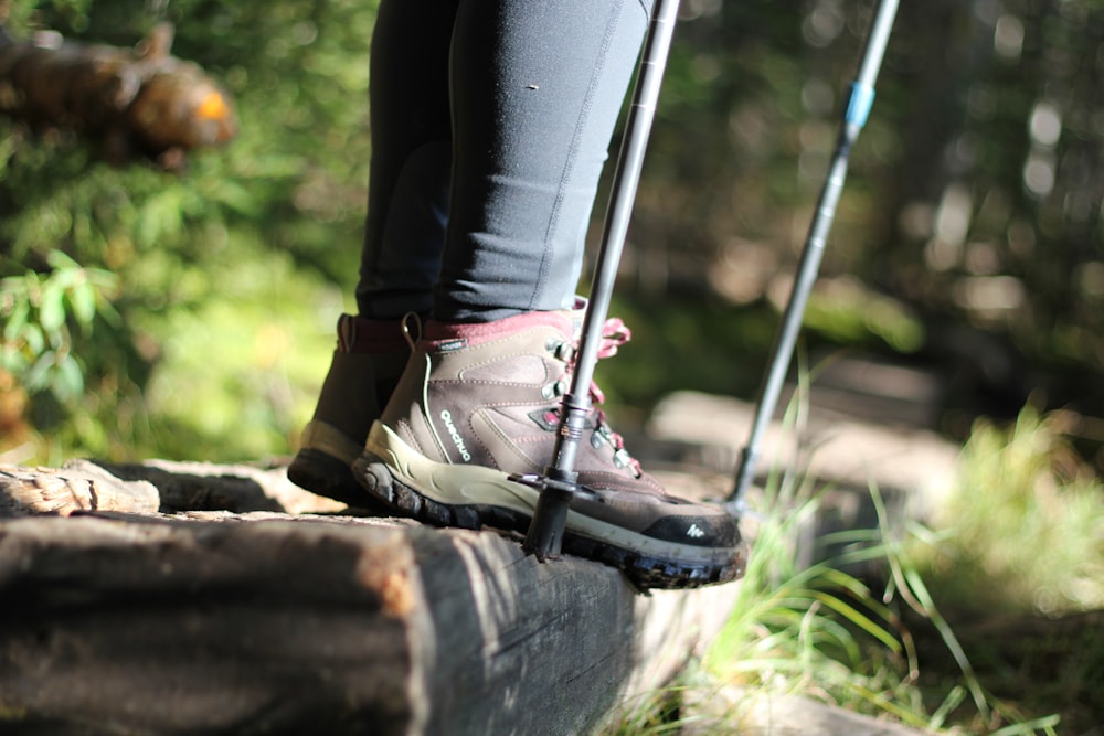person wearing black and pink hiking boots