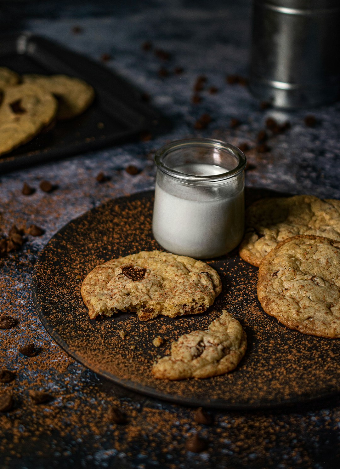 cookies beside milk in clear glass jar