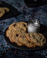 Freshly baked cookies stacked on a rustic plate with a glass of milk